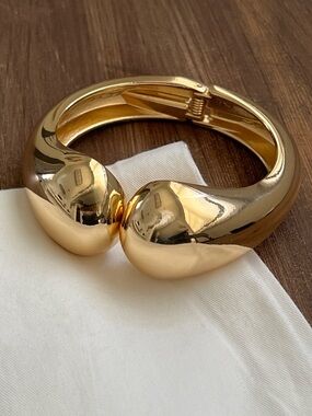 Gold tone clasp bangle bracelet